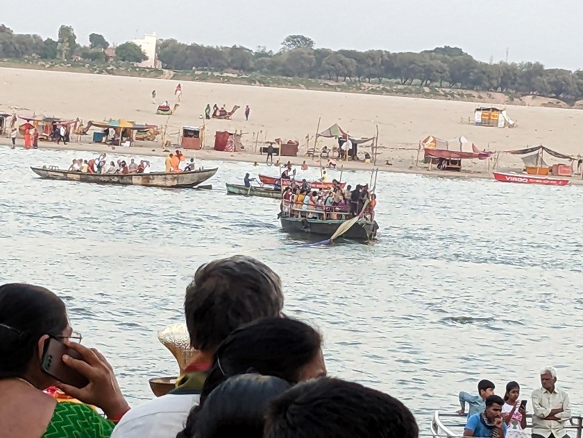 boat carrying sacred cloth and garland going across the river at Dashashwamedh ghat Varanasi